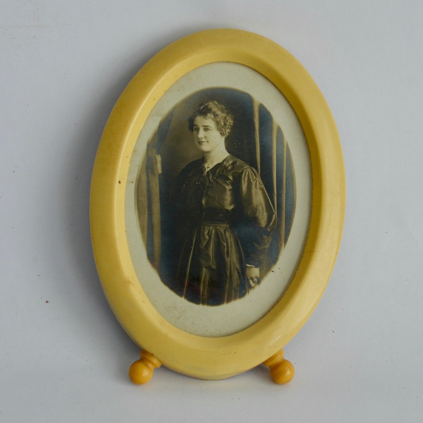 Vintage Celluloid Oval Footed Picture Frame with Antique Photo of Woman in Black Dress