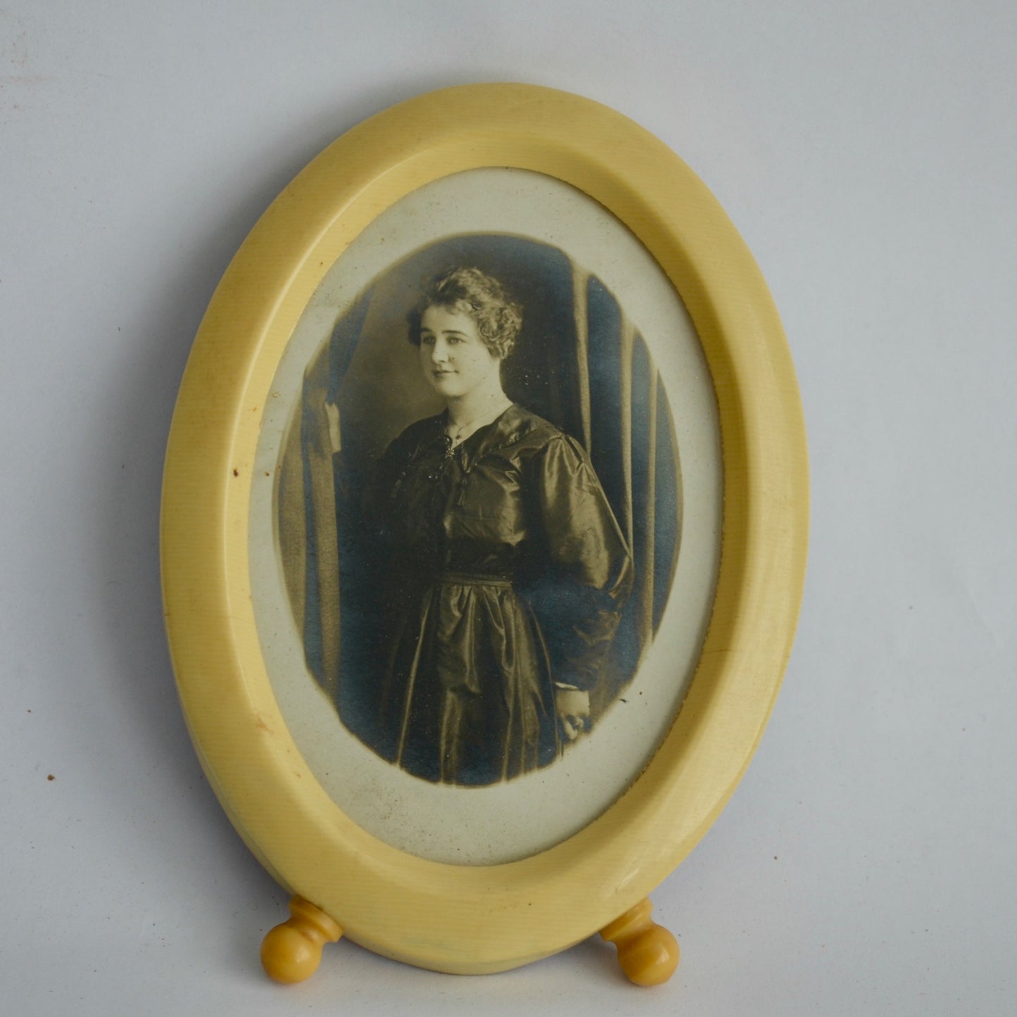 Vintage Celluloid Oval Footed Picture Frame with Antique Photo of Woman in Black Dress