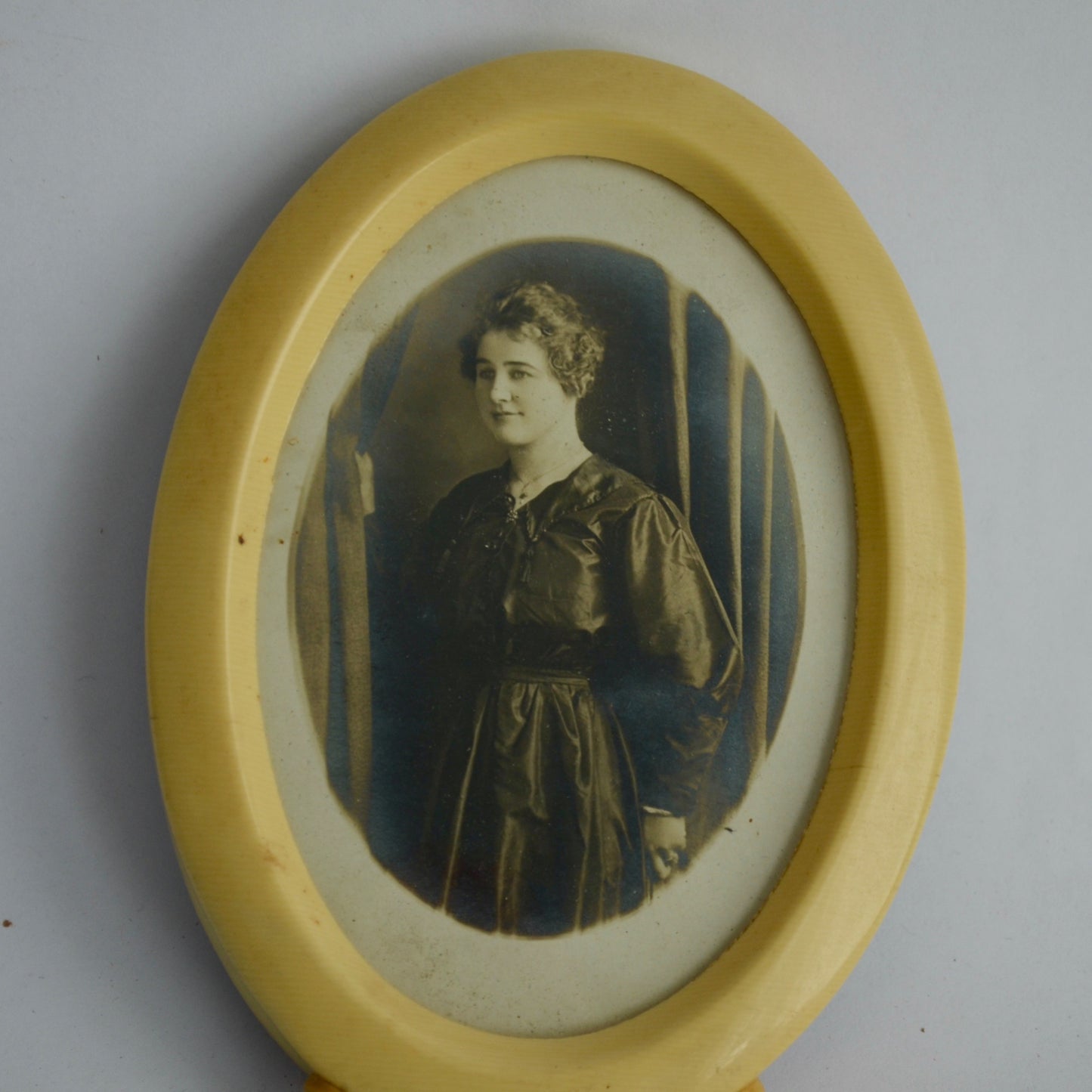 Vintage Celluloid Oval Footed Picture Frame with Antique Photo of Woman in Black Dress