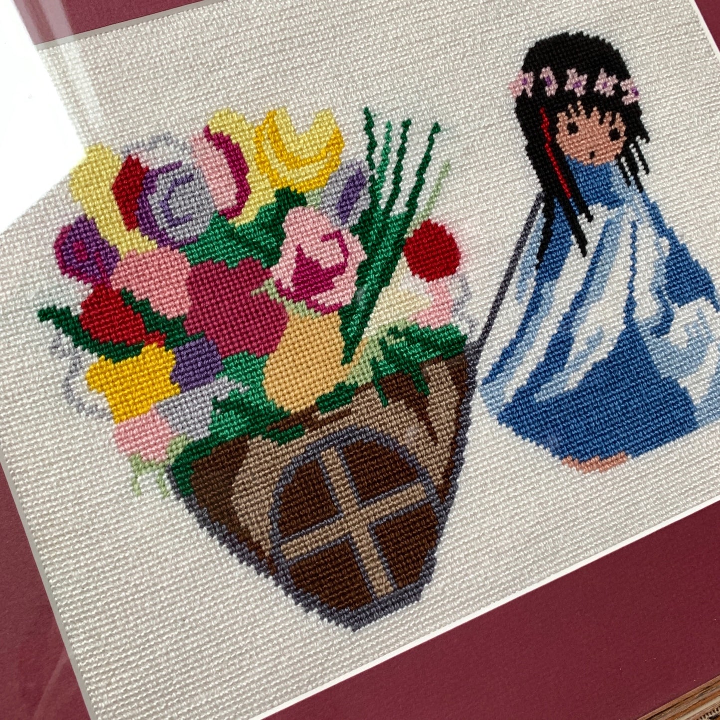 1970’s Framed De Grazia Needlepoint Native Girl with Basket of Flowers 18 x 15.25"