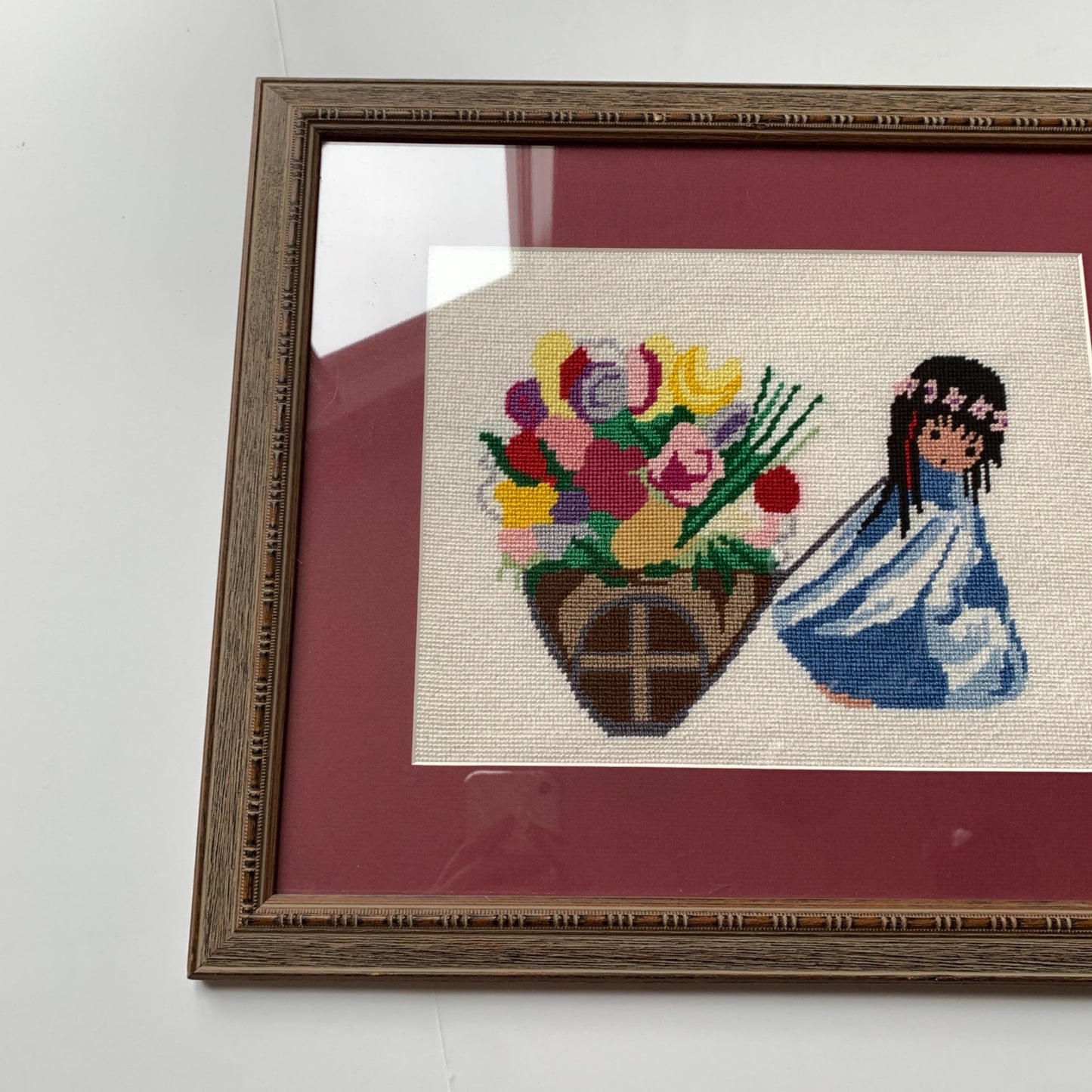 1970’s Framed De Grazia Needlepoint Native Girl with Basket of Flowers 18 x 15.25"